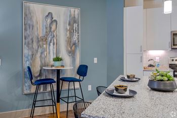 kitchen with granite countertops and seating area at LynnCora in Grand Prairie, TX