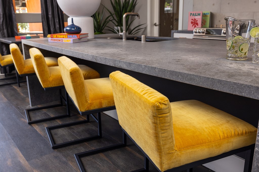 Resident lounge with yellow chairs and  counter seating