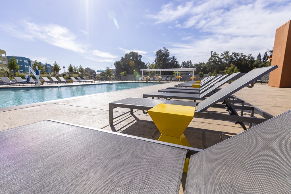 Pool lounge area at Solasta Apartments