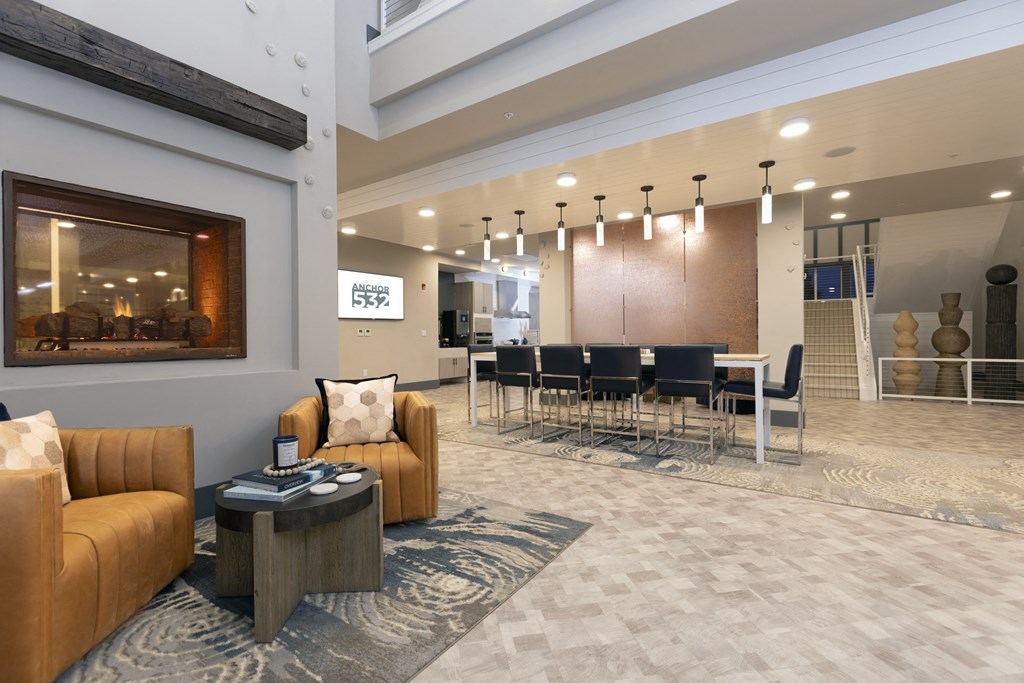 a large lobby with couches and chairs and a table with chairs