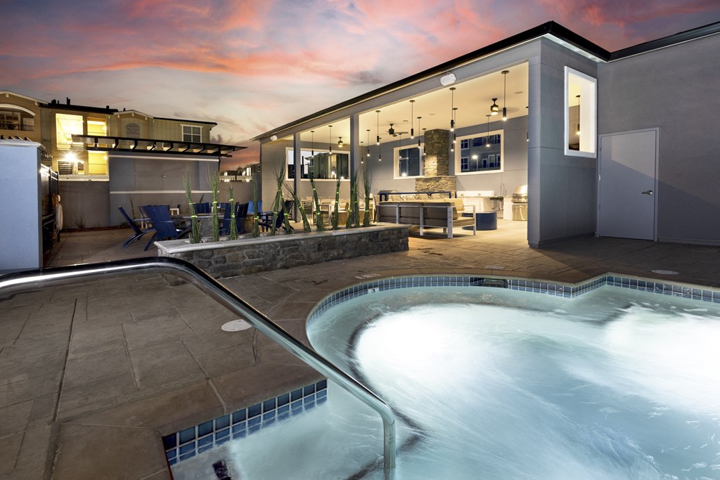 a spa with a pool and a house in the background