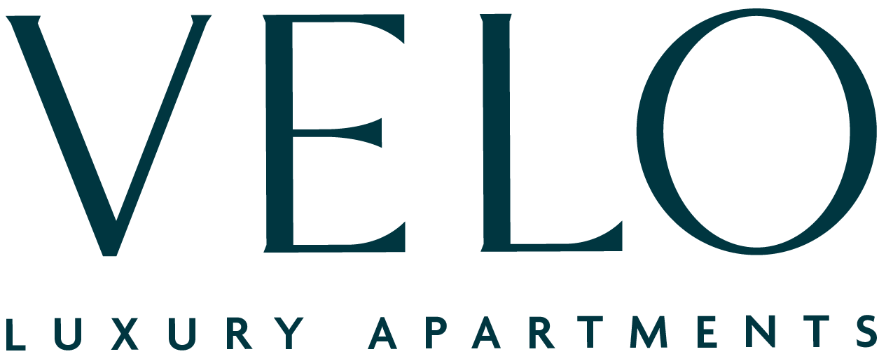 A sign that says Velo Luxury Apartments.