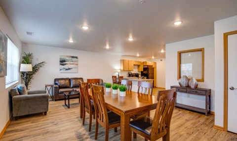A dining room with a wooden table and chairs.