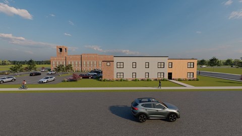 A car is parked in a parking lot in front of a building.