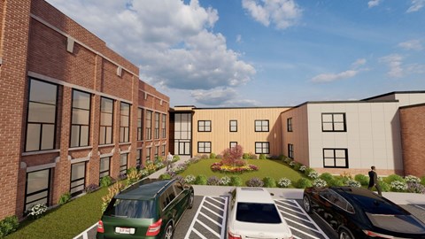 A modern building with a parking lot in front.