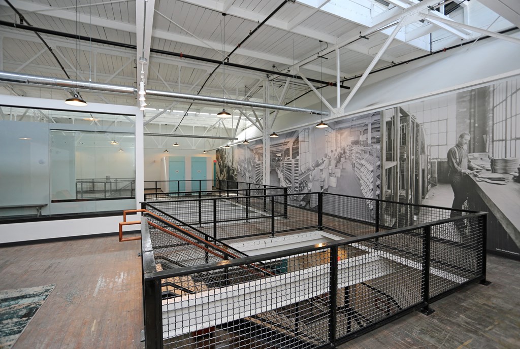 A room with a glass wall and a staircase.