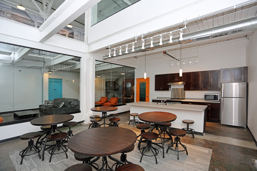 A modern kitchen with a glass ceiling and a dining table with chairs.