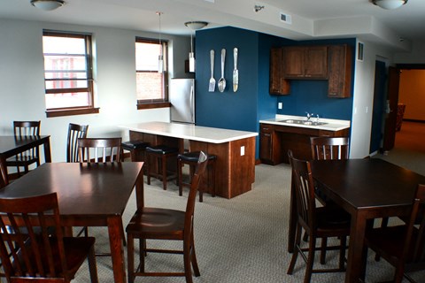A kitchen with a table and chairs.
