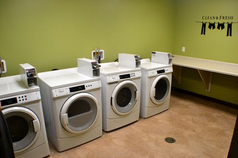 A row of washing machines in a laundromat.