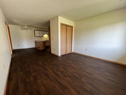 A room with wooden floors and a ceiling fan.