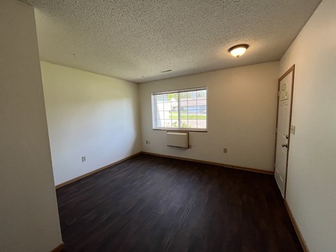 A room with a window and a door.