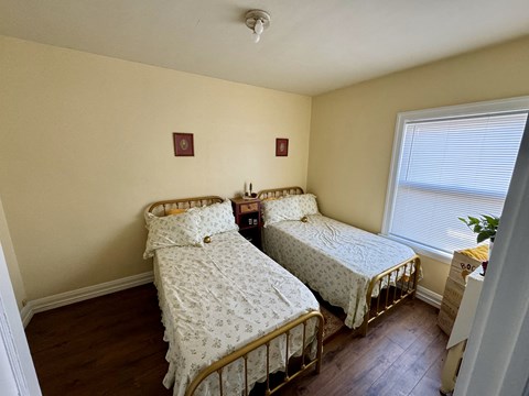 a bedroom with two beds and a window