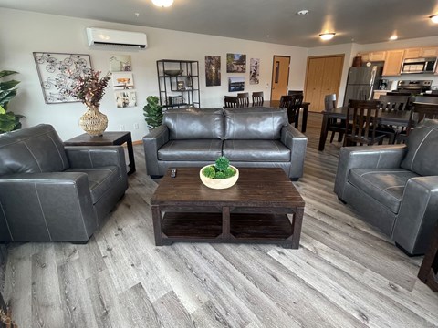 A living room with grey couches and a wooden coffee table.
