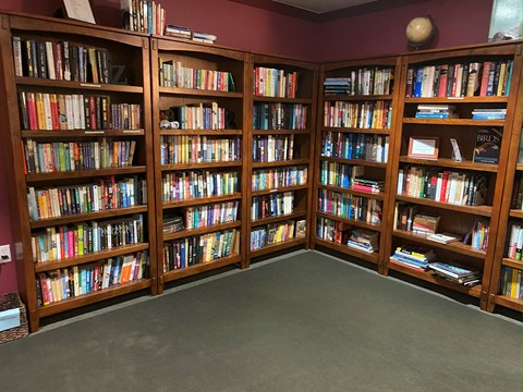 Library filled with bookshelves containing a variety of books.