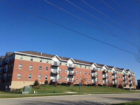 Apartment building with red brick and white trim.