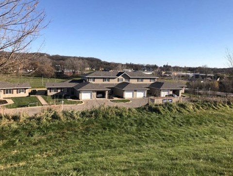 A residential area with houses and greenery.
