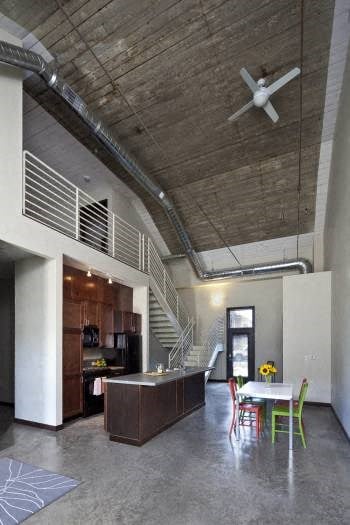 A room with a ceiling fan and a staircase.
