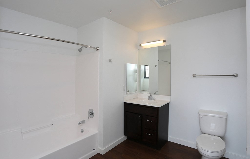 A white bathroom with a toilet, sink, and bathtub.