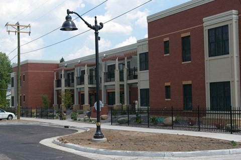 A street lamp stands in front of a building.