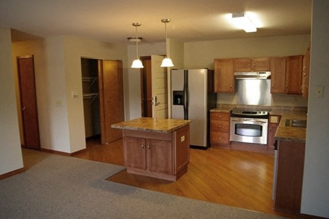 A kitchen with wooden cabinets and a central island.