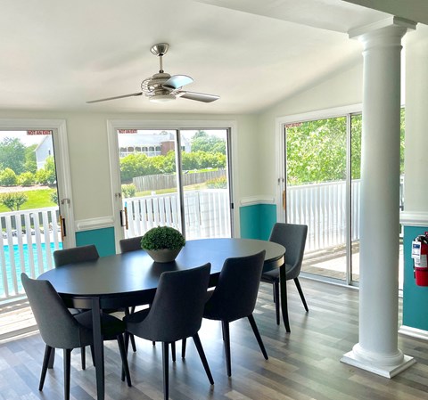 a dining room with a table and chairs and a ceiling fan