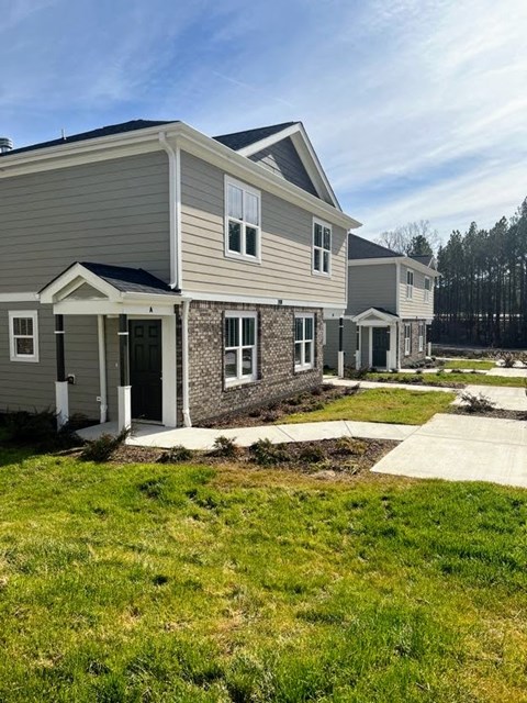 a house with a sidewalk in front of it