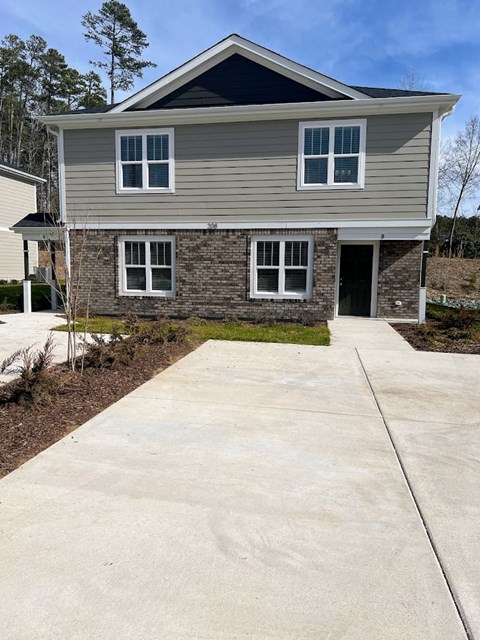 a house with a sidewalk in front of it