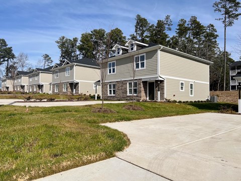 a row of houses with a sidewalk in front of them