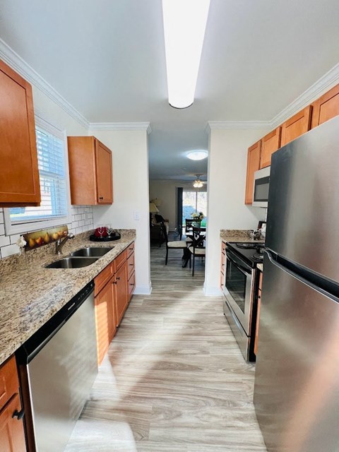 a kitchen with stainless steel appliances and wooden cabinets