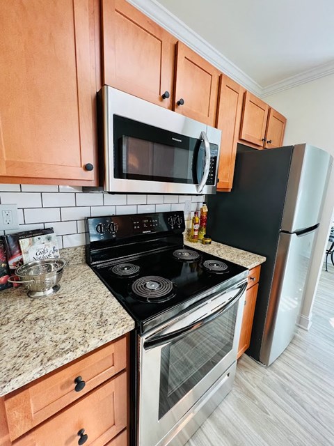 a kitchen with a stove microwave and refrigerator