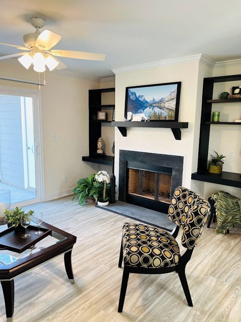 a living room with a fireplace and a chair