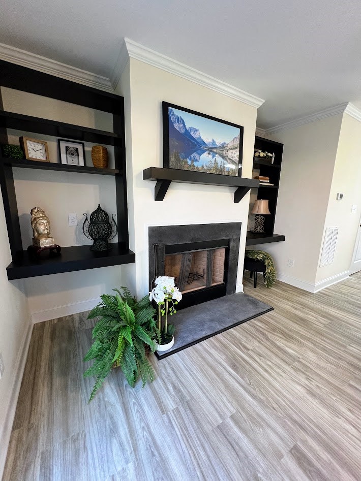 a living room with a fireplace and a plant