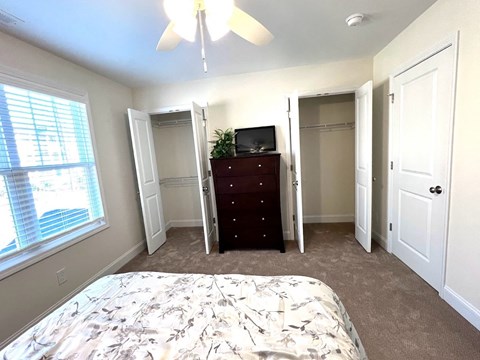 a bedroom with a bed and a dresser and a window