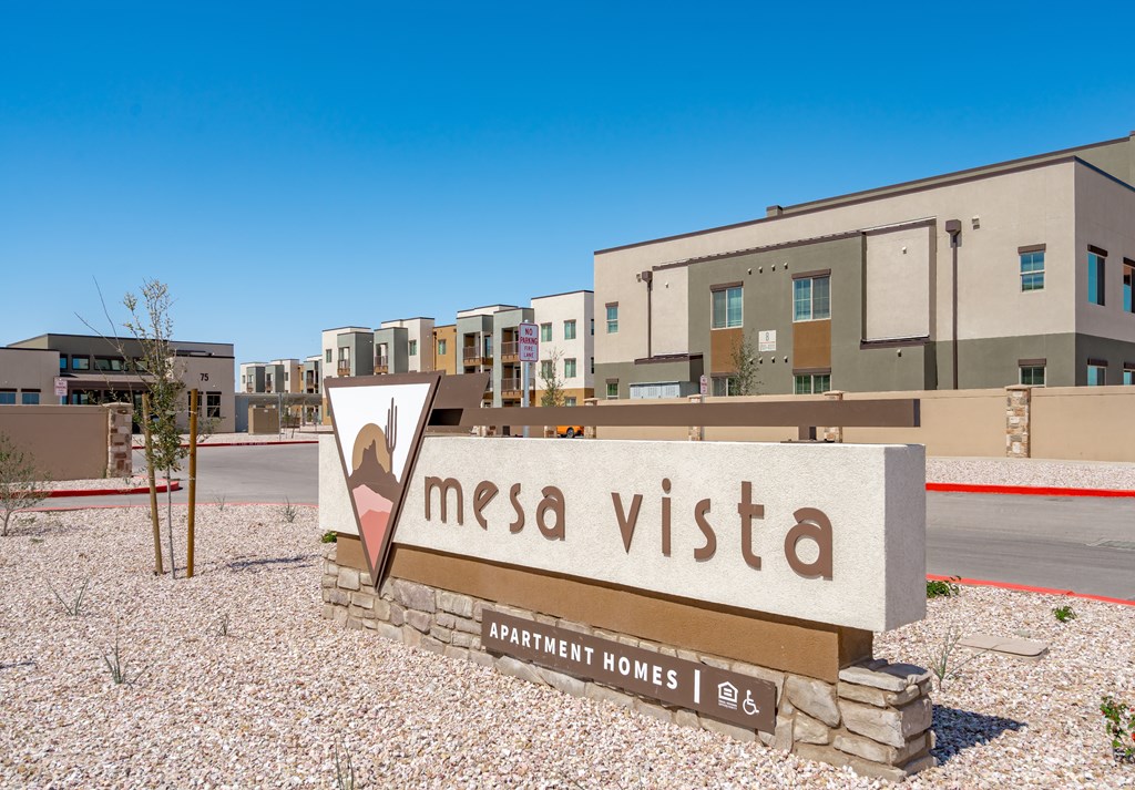 A sign for Mesa Vista Apartment Homes is in front of a building.