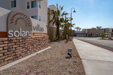 A sign for Solana Villas Apartment Homes is shown in front of a building.