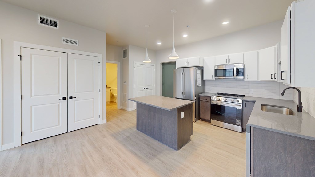 A modern kitchen with a large island in the middle.