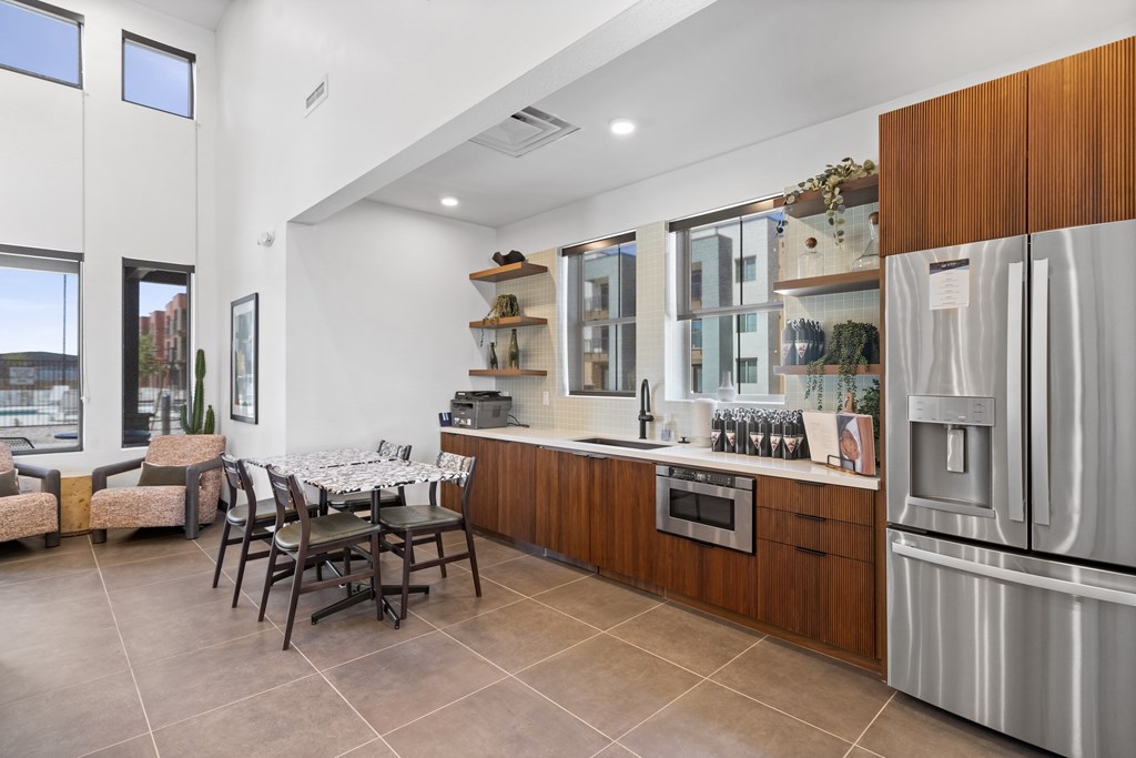 A modern kitchen with a dining table and chairs.