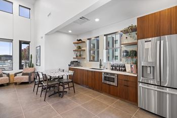 A modern kitchen with a dining table and chairs.