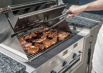 a man is cooking meat on a grill