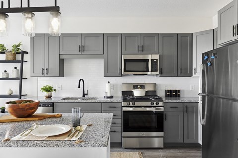 A modern kitchen with a refrigerator on the right.