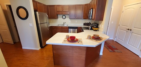 a kitchen with wooden cabinets and a white counter top