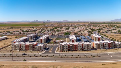 A large housing development in a desert-like area with a clear blue sky.