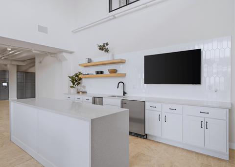 A modern kitchen with white cabinets and a large island.
