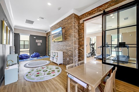 A modern kitchen with a wooden table and chairs.