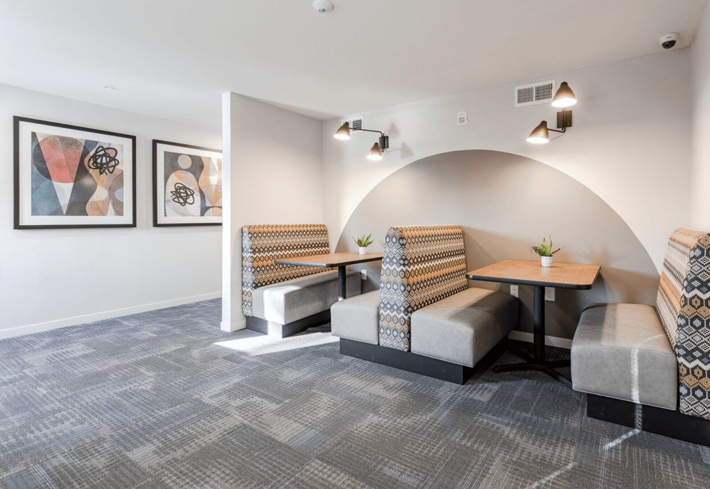 a lounge area with couches and chairs and a table