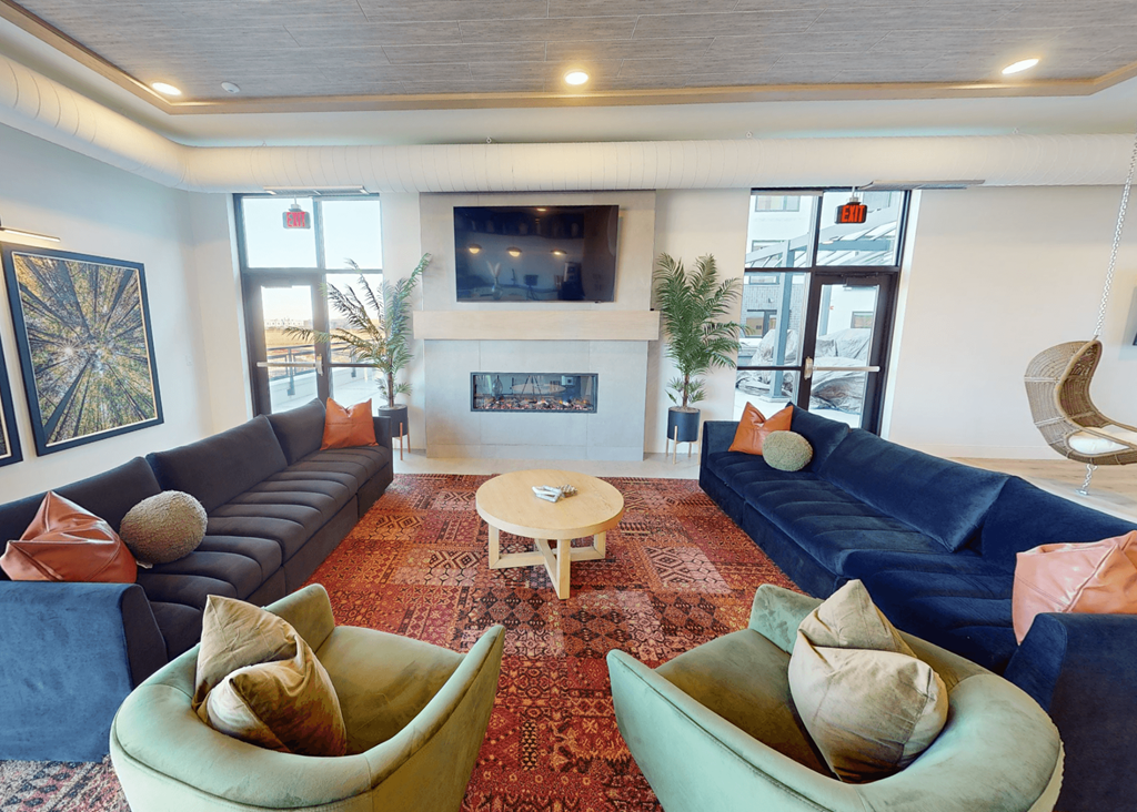 a living room with couches and chairs and a fireplace