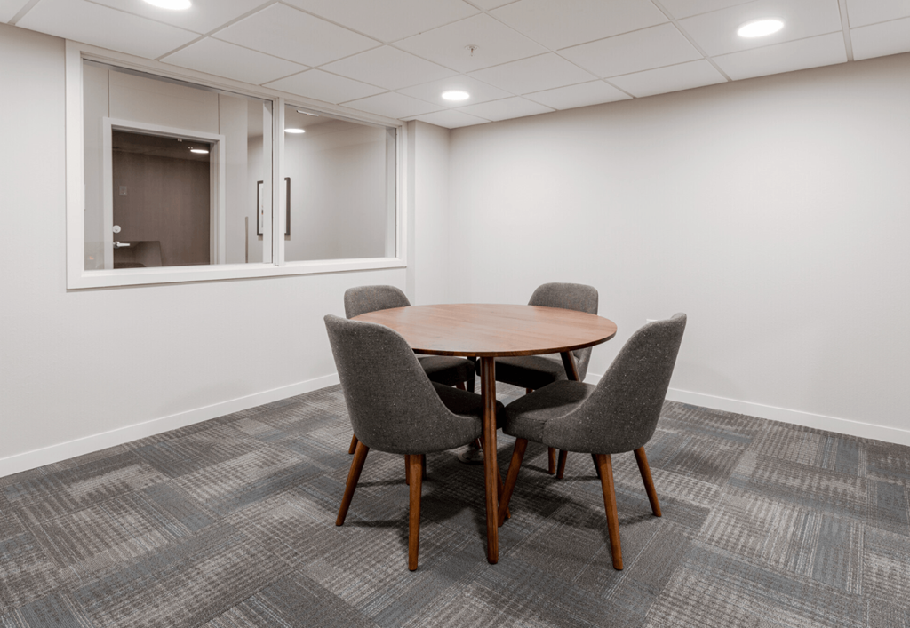 a room with a wooden table and chairs