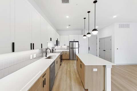 A modern kitchen with wooden cabinets and a white countertop.