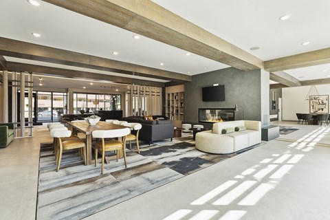A modern living room with a large table and chairs.
