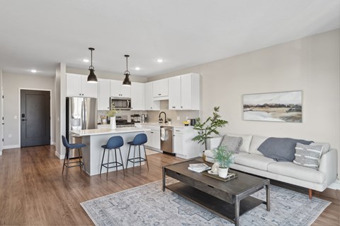A modern kitchen with white cabinets and a breakfast bar.